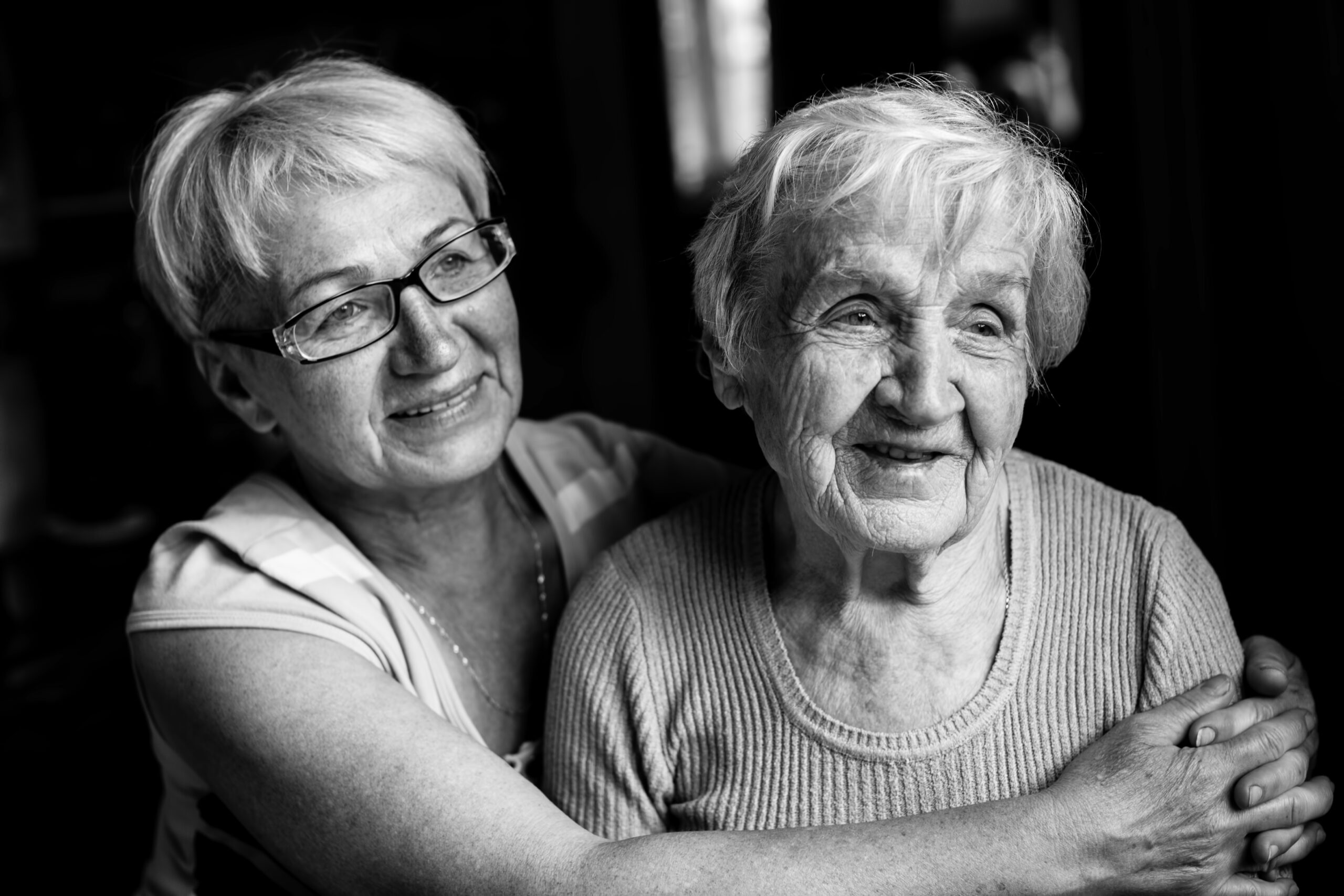 Portrait of an old woman with her adult daughter. Black and white photography. Portrait of an old woman with her adult daughter. Black and white photography.
